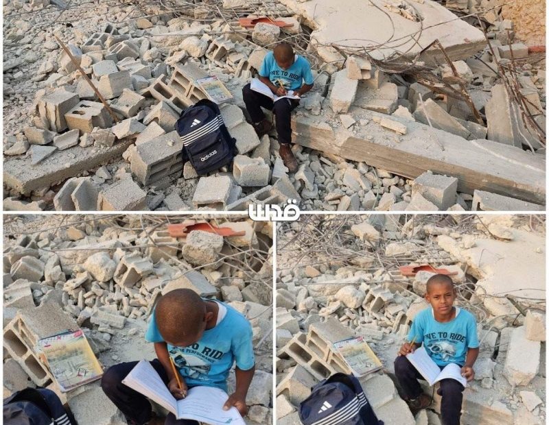 A Palestinian child does his homework in rubbles of what used to be his home whi...